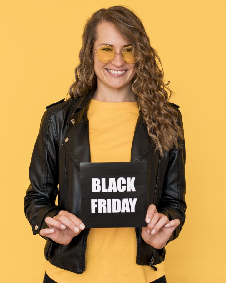 woman wearing glasses holding black friday label